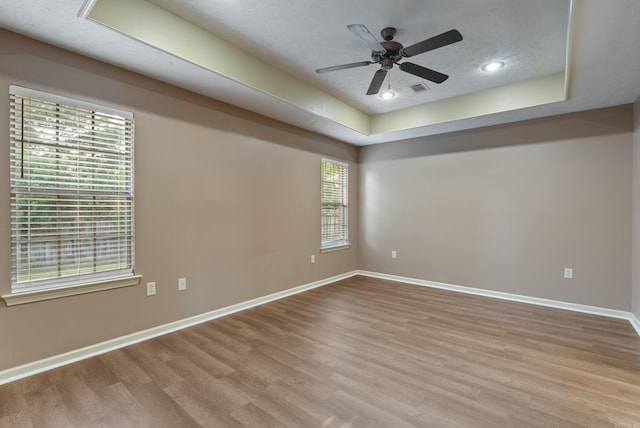 970 Wineberry, Conway, AR 72034 - empty room featuring a raised ceiling, wood finished floors, ceiling fan, and recessed lighting
