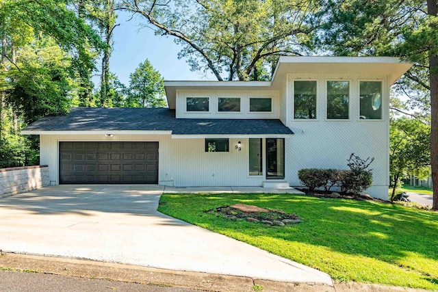 99Rogers Drive, Bryant, AR 72022 - view of front of home with an attached garage, a front lawn, concrete driveway, and roof with shingles