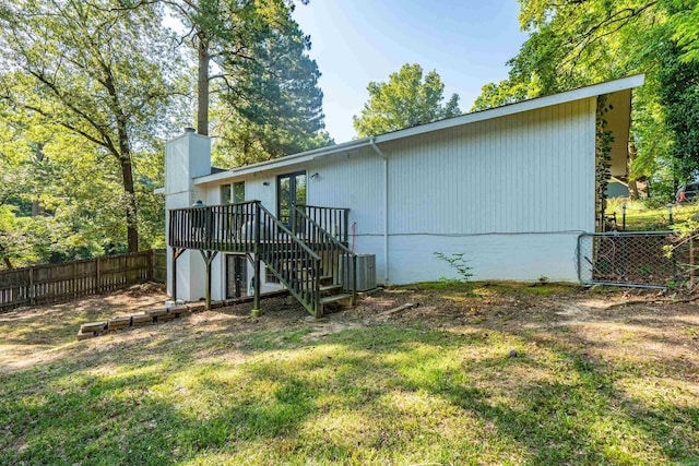 99Rogers Drive, Bryant, AR 72022 - rear view of property featuring stairs, a fenced backyard, a wooden deck, and a chimney
