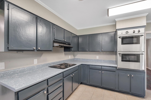 900 Melton Dr, Jonesboro, AR 72401 - kitchen with double oven, black electric cooktop, under cabinet range hood, crown molding, and light tile patterned floors