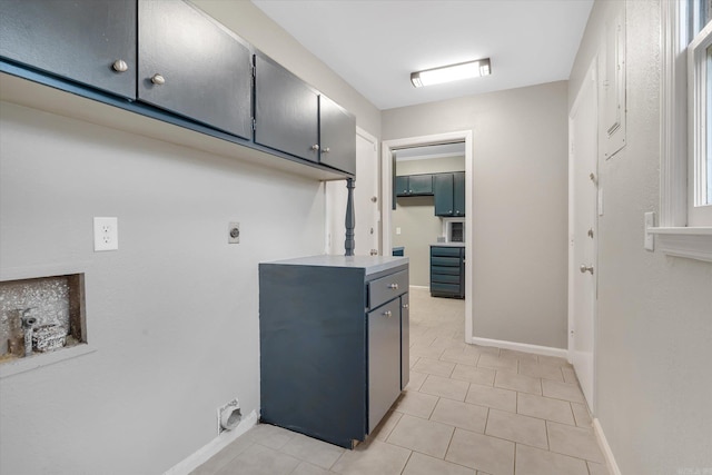 900 Melton Dr, Jonesboro, AR 72401 - washroom featuring hookup for an electric dryer, cabinet space, and light tile patterned floors
