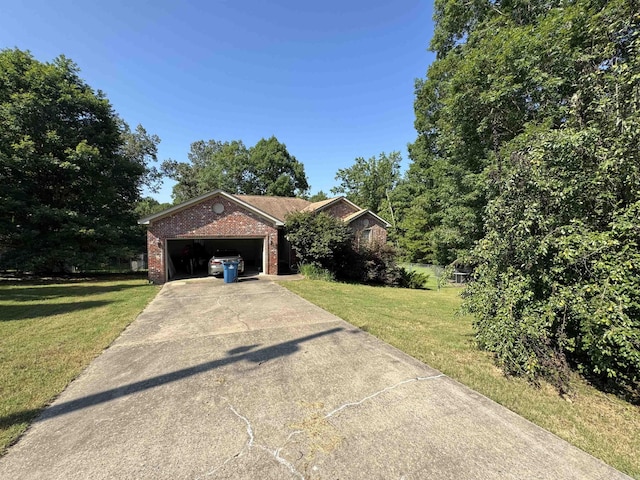 view of front of house with brick siding, concrete driveway, a front yard, and an attached garage