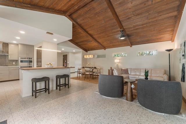 128 Dickson Dr, Little Rock, AR 72207 - living room featuring a wood ceiling with exposed beams, dark aggregate flooring, recessed lighting, and high vaulted ceiling