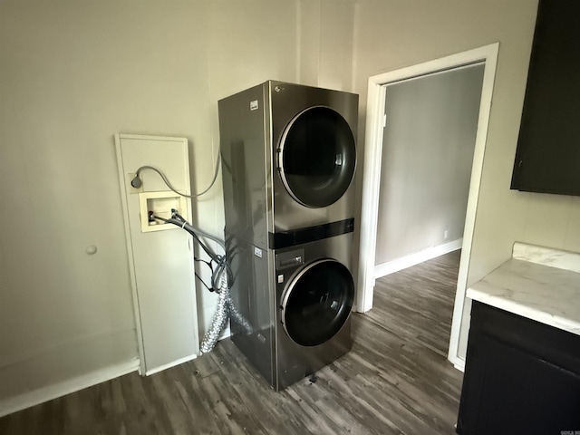 2417 Wolfe St, Little Rock, AR 72206 - washroom with stacked washer and clothes dryer and dark wood-type flooring