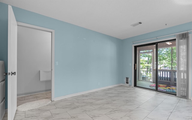 9 San Vincente Pl, Hot Springs Village, AR 71909 - empty room featuring marble look tiles and baseboards