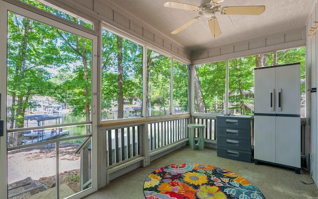9 San Vincente Pl, Hot Springs Village, AR 71909 - unfurnished sunroom featuring a ceiling fan, a water view, and plenty of natural light