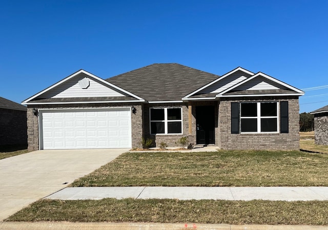 view of front facade featuring an attached garage, concrete driveway, a front yard, and brick siding