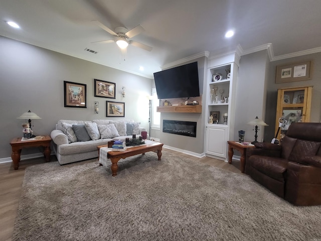 6413 Ram Rd, Mabelvale, AR 72103 - living area with ceiling fan, crown molding, wood finished floors, a glass covered fireplace, and recessed lighting