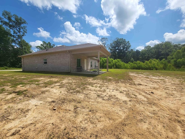 6413 Ram Rd, Mabelvale, AR 72103 - rear view of house with a patio and brick siding