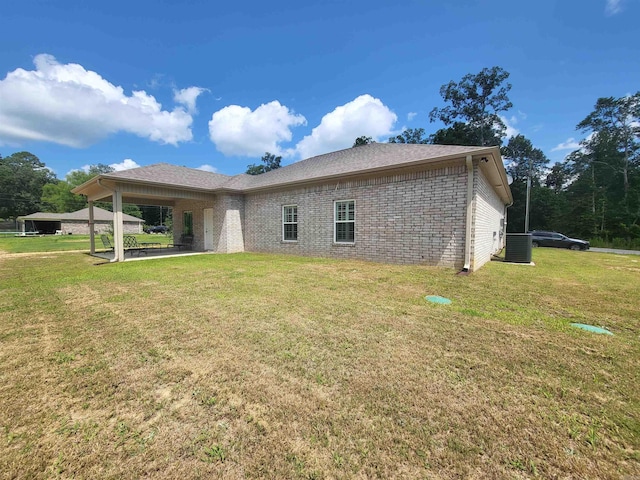 6413 Ram Rd, Mabelvale, AR 72103 - rear view of property featuring brick siding, a patio area, and a yard