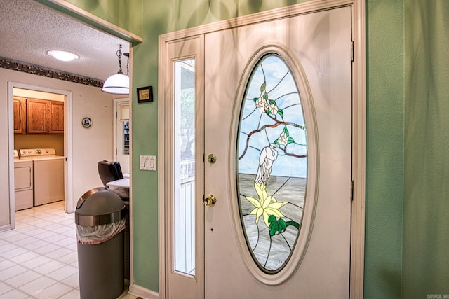 5 Lanza Ct, Hot Springs Village, AR 71909 - foyer featuring separate washer and dryer, light tile patterned floors, and a textured ceiling