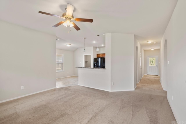 9701 Zuber, Alexander, AR 72002 - unfurnished living room featuring light carpet, arched walkways, and a ceiling fan