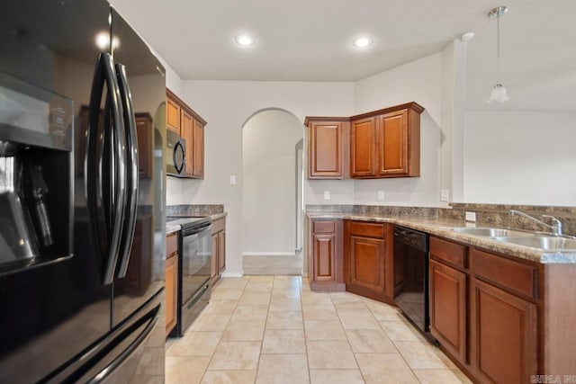 9701 Zuber, Alexander, AR 72002 - kitchen with black appliances, arched walkways, brown cabinetry, hanging light fixtures, and a peninsula