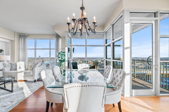 521 E President Clinton Ave Unit 1402, Little Rock, AR 72201 - dining space featuring a chandelier and wood finished floors