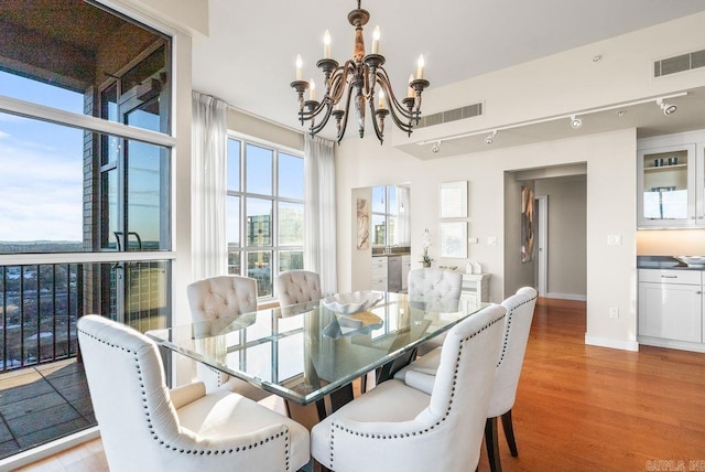 521 E President Clinton Ave Unit 1402, Little Rock, AR 72201 - dining space featuring a chandelier and light wood-type flooring