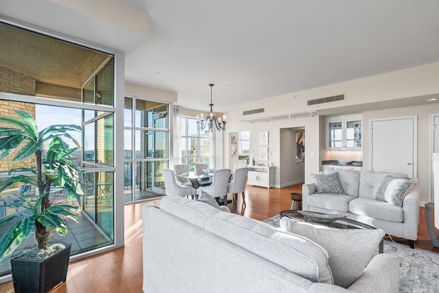521 E President Clinton Ave Unit 1402, Little Rock, AR 72201 - living area with a chandelier, wood finished floors, and plenty of natural light