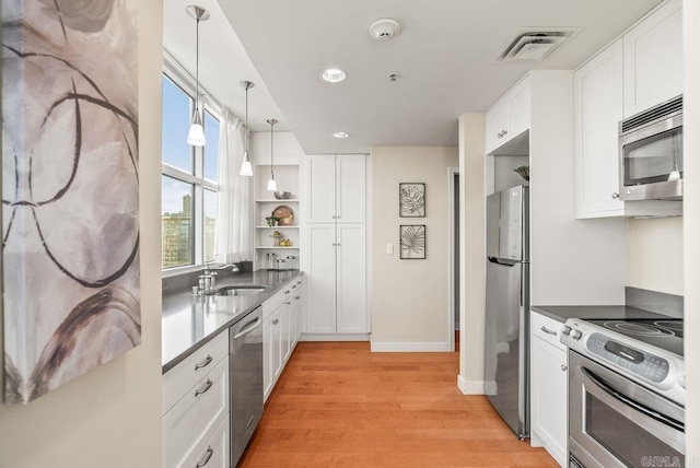 521 E President Clinton Ave Unit 1402, Little Rock, AR 72201 - kitchen featuring appliances with stainless steel finishes, light wood-style floors, open shelves, white cabinets, and recessed lighting