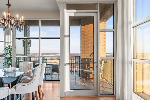 521 E President Clinton Ave Unit 1402, Little Rock, AR 72201 - dining area featuring a chandelier, plenty of natural light, wood finished floors, and floor to ceiling windows