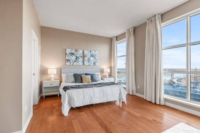 521 E President Clinton Ave Unit 1402, Little Rock, AR 72201 - bedroom featuring light wood-style flooring and baseboards