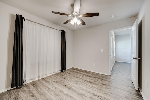 1375 Lacroix Ln, Conway, AR 72034 - empty room featuring wood finished floors, ceiling fan, and a smoke detector