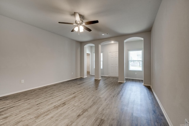 1375 Lacroix Ln, Conway, AR 72034 - unfurnished room with wood finished floors, arched walkways, and a ceiling fan