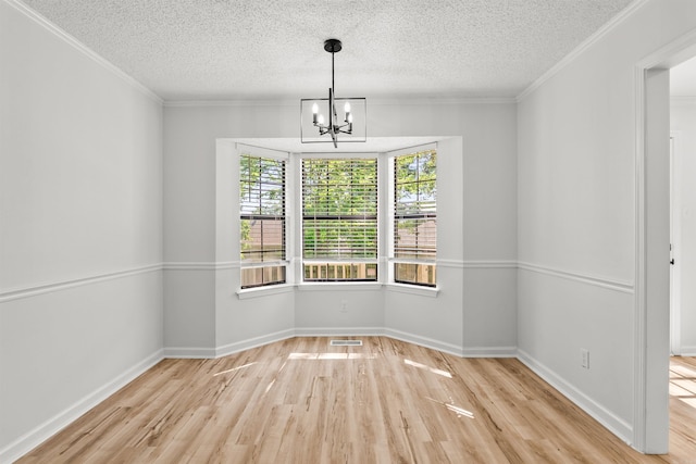 120 Whitewood Dr, Sherwood, AR 72120 - empty room with wood finished floors, a textured ceiling, a chandelier, and crown molding