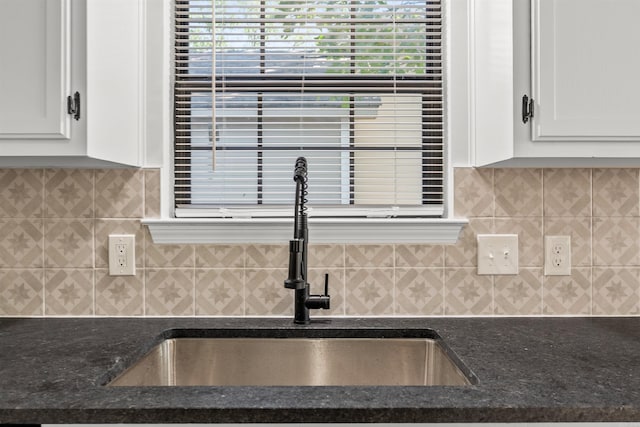 120 Whitewood Dr, Sherwood, AR 72120 - kitchen view of white cabinets, dark stone countertops, and backsplash