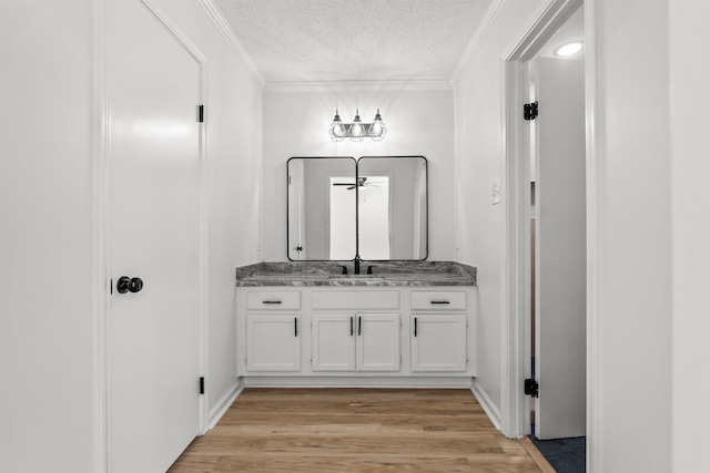 120 Whitewood Dr, Sherwood, AR 72120 - bathroom featuring vanity, ornamental molding, a textured ceiling, and wood finished floors