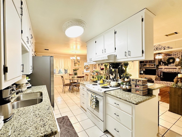 1912 W Arch Ave, Searcy, AR 72143 - kitchen featuring white electric stove, light tile patterned flooring, a chandelier, and white cabinets