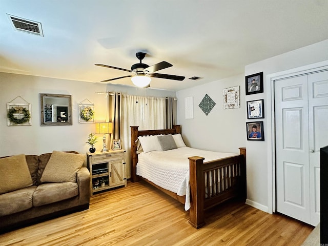 1912 W Arch Ave, Searcy, AR 72143 - bedroom with light wood finished floors, ceiling fan, and a closet