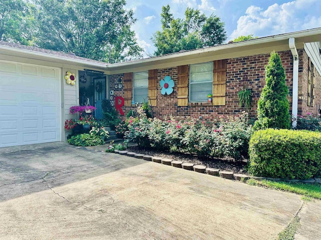 1912 W Arch Ave, Searcy, AR 72143 - view of front of home with brick siding, driveway, and a garage
