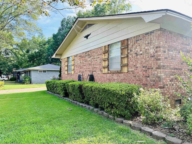 1912 W Arch Ave, Searcy, AR 72143 - view of property exterior with a lawn and brick siding
