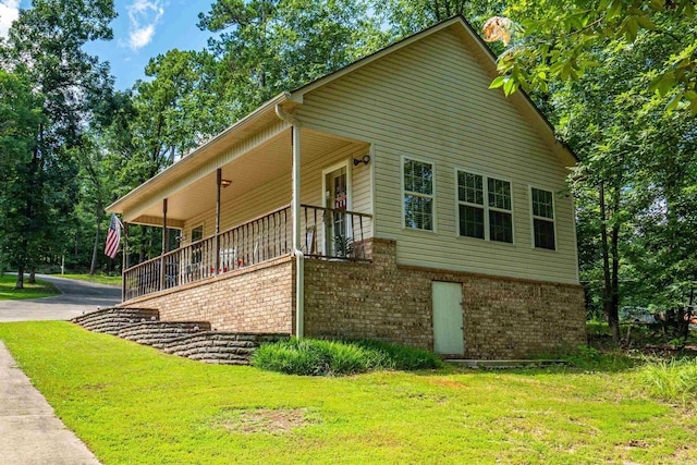 529 Charlie Stover, Royal, AR 71968 - view of property exterior featuring brick siding, a lawn, driveway, and covered porch