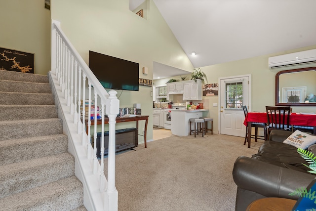 529 Charlie Stover, Royal, AR 71968 - living area with a wall mounted air conditioner, stairway, light carpet, and high vaulted ceiling