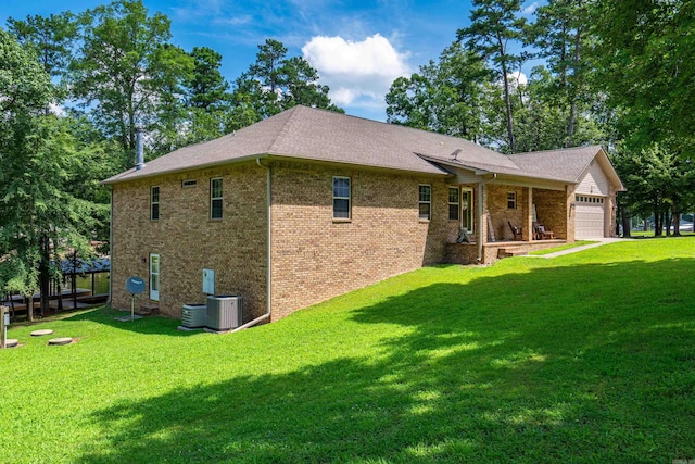 529 Charlie Stover, Royal, AR 71968 - back of house featuring a garage, brick siding, a yard, and a shingled roof