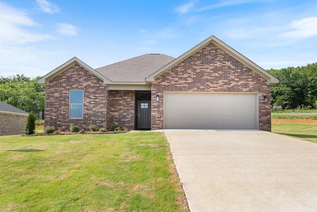 85 Lewis Loop, Greenbrier, AR 72058 - view of front facade with concrete driveway, brick siding, a front lawn, an attached garage, and a shingled roof
