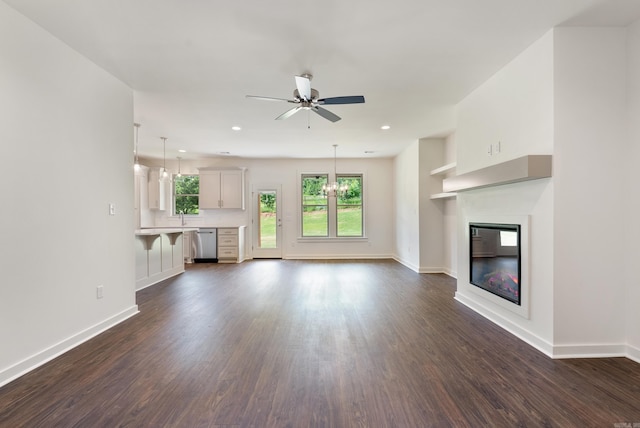 85 Lewis Loop, Greenbrier, AR 72058 - unfurnished living room with dark wood-type flooring, a glass covered fireplace, healthy amount of natural light, and recessed lighting