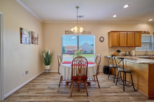 4116 Wildflower Ln, Benton, AR 72015 - dining area with a chandelier, healthy amount of natural light, light wood finished floors, crown molding, and recessed lighting