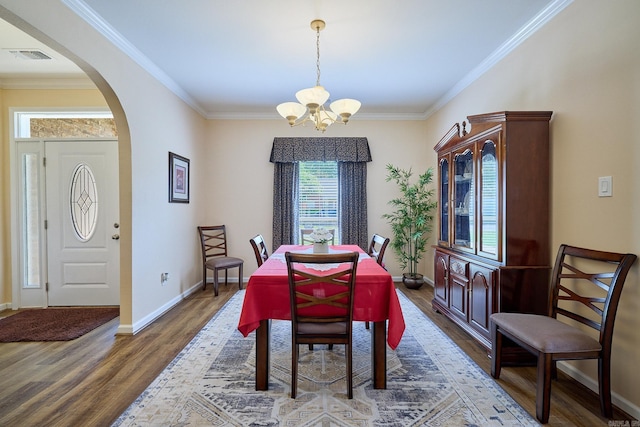 4116 Wildflower Ln, Benton, AR 72015 - dining area featuring a chandelier, arched walkways, wood finished floors, and crown molding