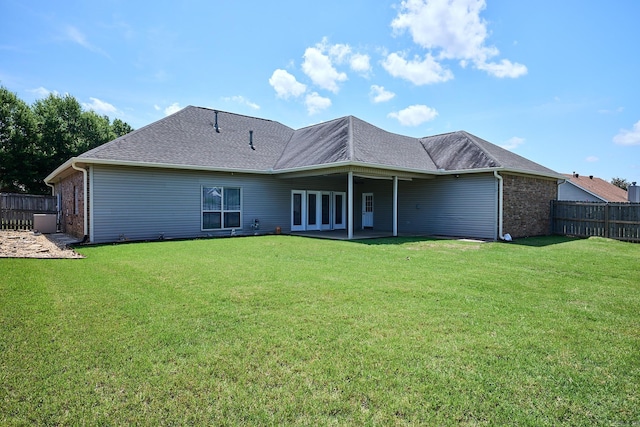 4116 Wildflower Ln, Benton, AR 72015 - back of property with brick siding, a patio area, and a shingled roof