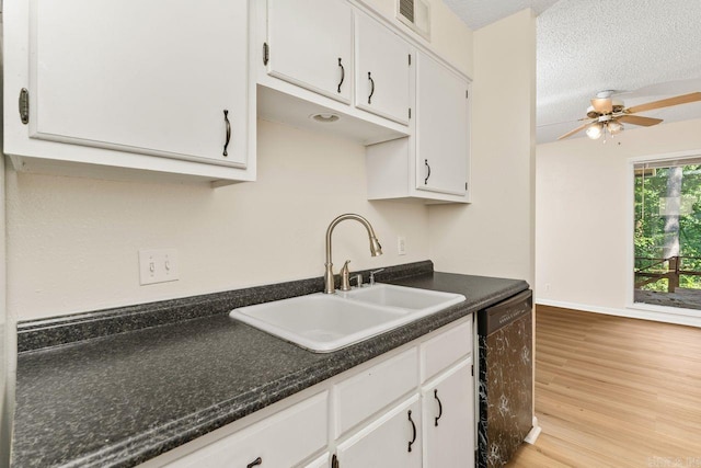 154 La Vista Ln, Hot Springs Village, AR 71909 - kitchen featuring dishwasher, white cabinets, dark countertops, light wood-style floors, and a textured ceiling