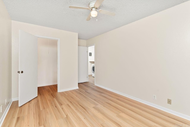 154 La Vista Ln, Hot Springs Village, AR 71909 - unfurnished bedroom featuring light wood-type flooring, a closet, a textured ceiling, washer / clothes dryer, and ceiling fan