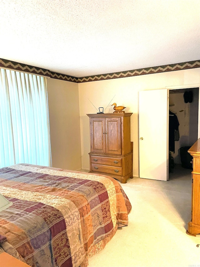 700 E 9th St Unit 6L, Little Rock, AR 72202 - bedroom with light carpet and a textured ceiling