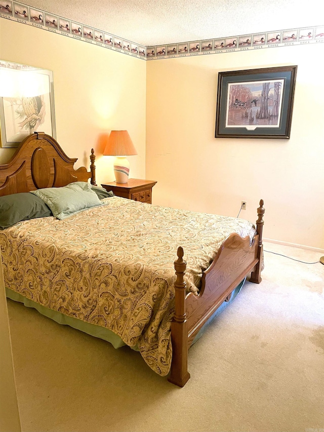 700 E 9th St Unit 6L, Little Rock, AR 72202 - carpeted bedroom featuring a textured ceiling and baseboards