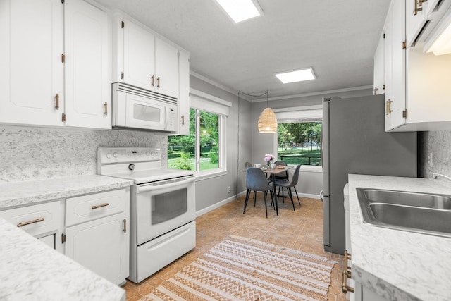 7616 Samples Rd, Benton, AR 72019 - kitchen featuring white appliances, light countertops, white cabinets, and hanging light fixtures
