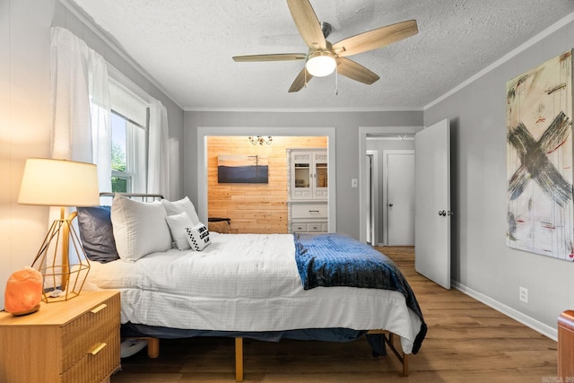 7616 Samples Rd, Benton, AR 72019 - bedroom with wood finished floors, a textured ceiling, crown molding, and ceiling fan