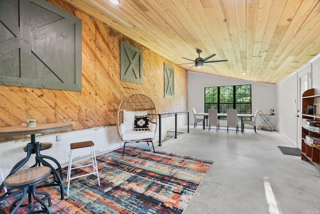 7616 Samples Rd, Benton, AR 72019 - living area featuring finished concrete floors, wood ceiling, wooden walls, lofted ceiling, and ceiling fan