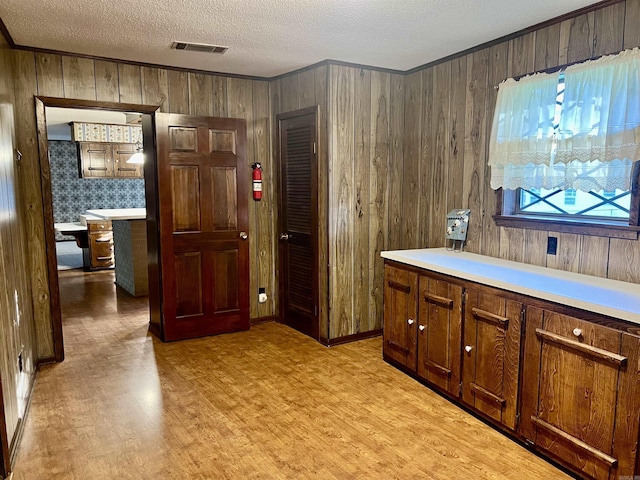 101 Fairway Dr, Bald Knob, AR 72010 - bar area with ornamental molding, light wood-style flooring, wooden walls, and a textured ceiling