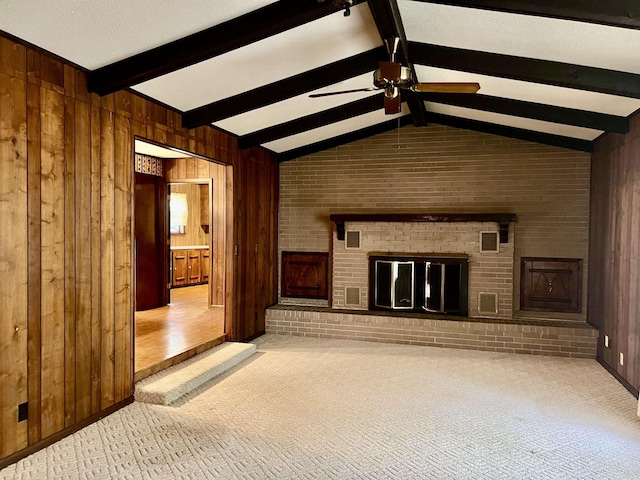 101 Fairway Dr, Bald Knob, AR 72010 - unfurnished living room featuring carpet flooring, a ceiling fan, a fireplace, wood walls, and brick wall