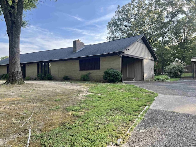 101 Fairway Dr, Bald Knob, AR 72010 - view of property exterior with brick siding, a chimney, and asphalt driveway
